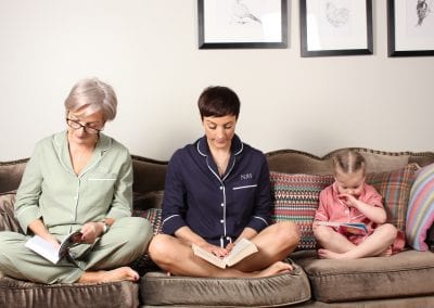 Family reading books on a sofa